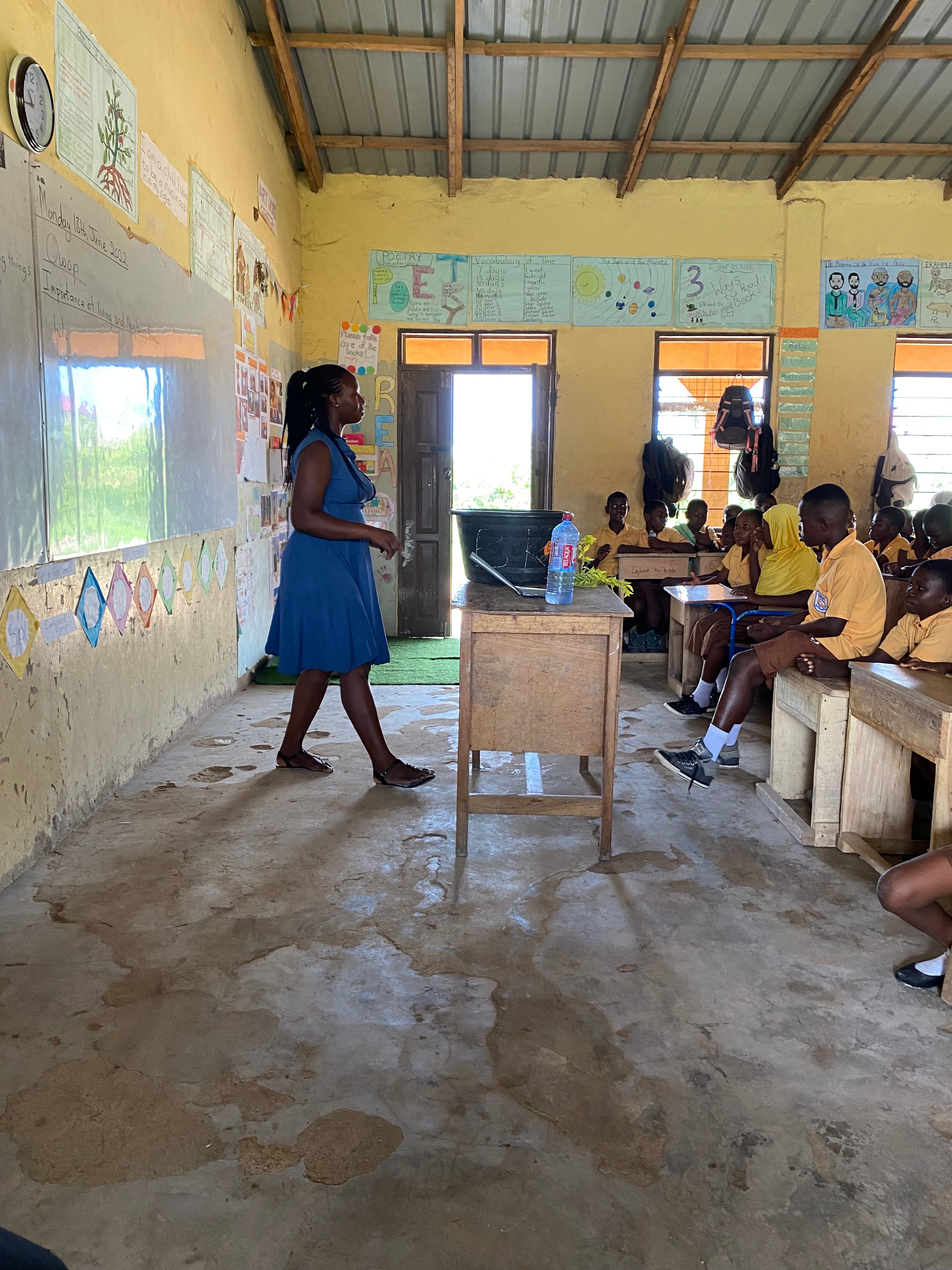 Educator with students in a classroom in Ghana