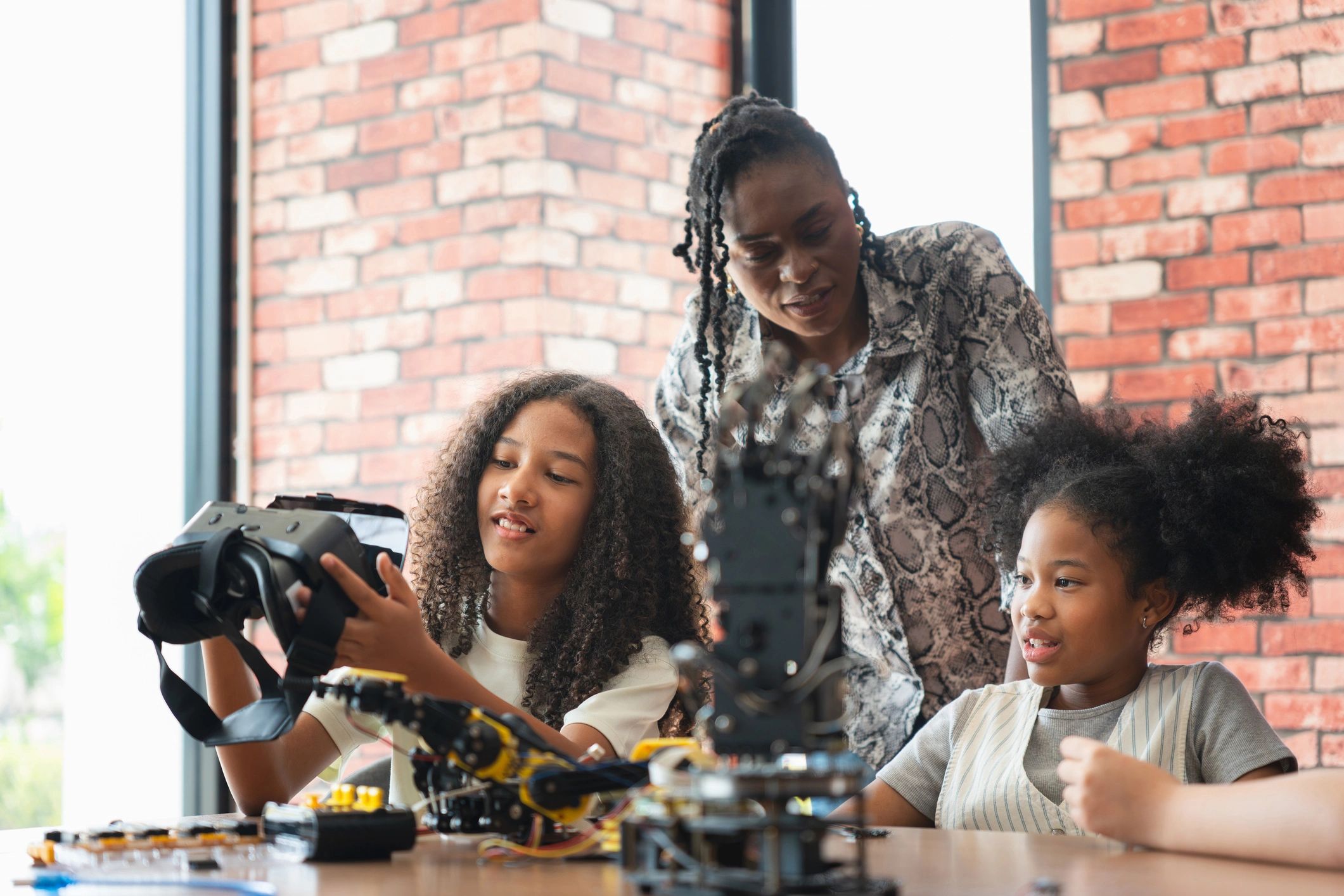 Woman and girls working on robotics